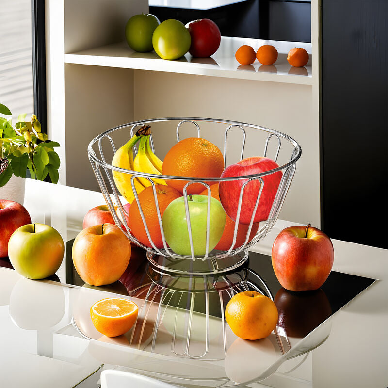 Fruit bowl with apples, oranges, and bananas on a kitchen counter.