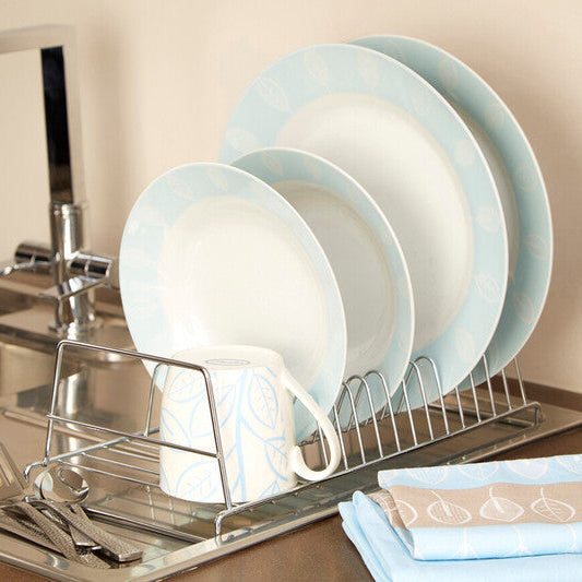 Dish rack with light blue plates and cups on a kitchen counter.