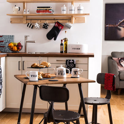 Kitchen with dining table, chairs, and a view of a cityscape on a wall.
