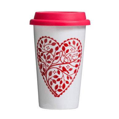 White travel mug with red heart design and lid on a white background
