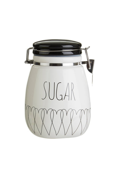 White sugar jar with black text and lid on a white background