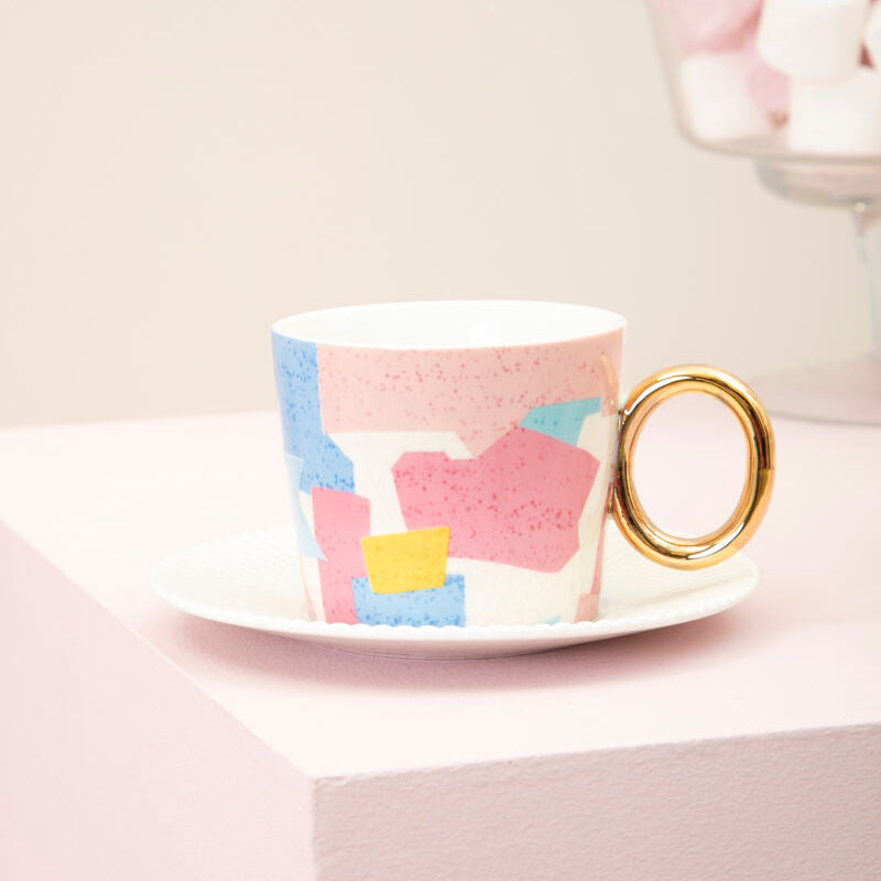 Colorful mug with abstract patterns on a white surface