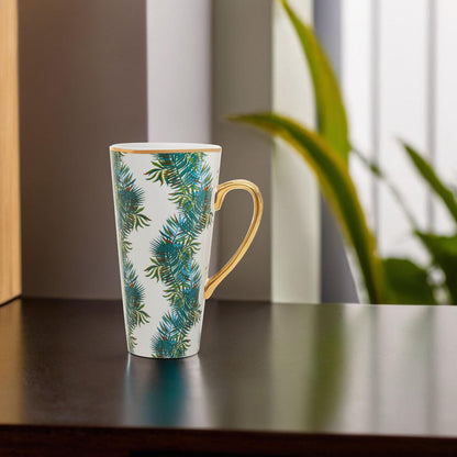 Mug with green leaf pattern on a wooden surface