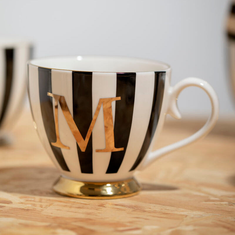Black and white striped teacup with gold letter &