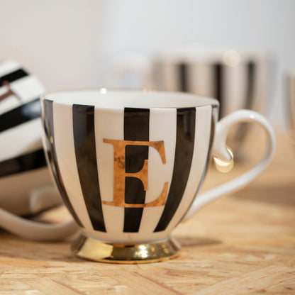 Teacup with black and white stripes and a gold letter &