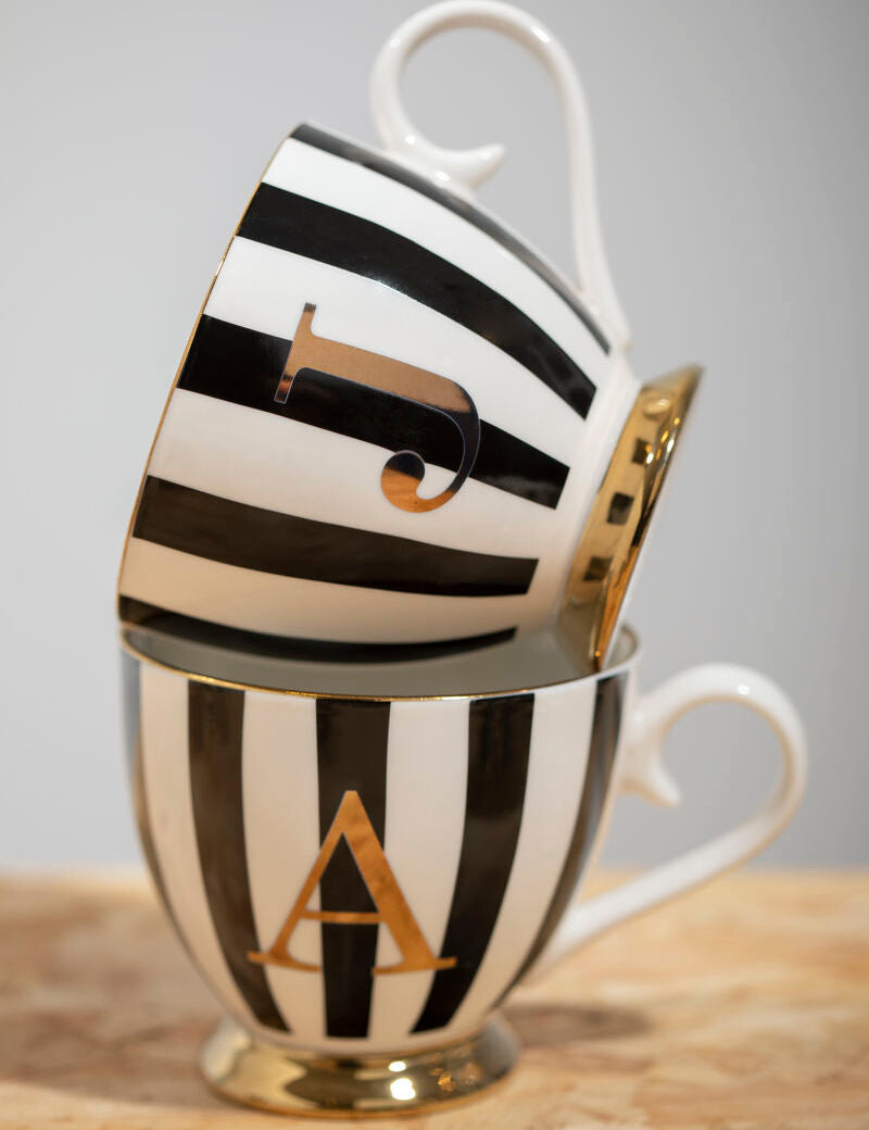 Black and white striped mug with gold letter &