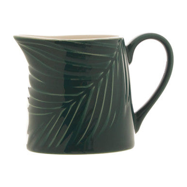 Green mug with leaf pattern on a white background