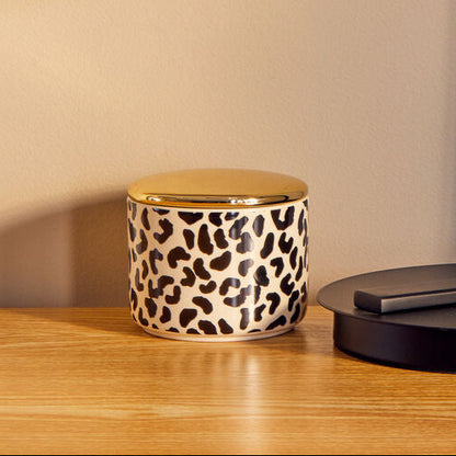 Black table lamp on a wooden surface with a beige background