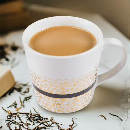 Cup of tea with oranges and books on a table, with &