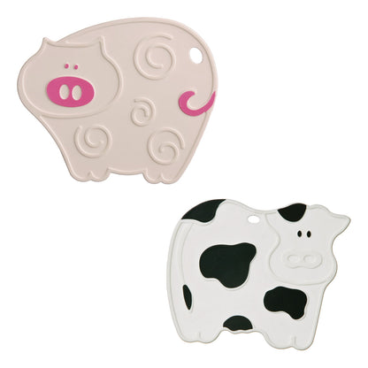 Two animal-shaped toys, one resembling a pig and the other a cow, on a white background.