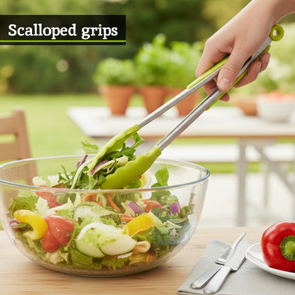 Person using salad tongs with scalloped grips to serve a salad in a glass bowl outdoors.