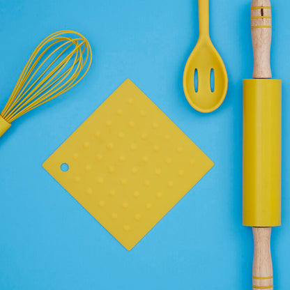 Yellow kitchen utensils including a whisk, spatula, cutting board, and rolling pin on a blue background