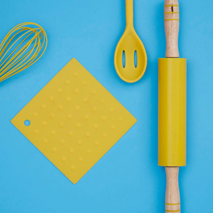 Yellow kitchen utensils including a whisk, spatula, cutting board, and rolling pin on a blue background