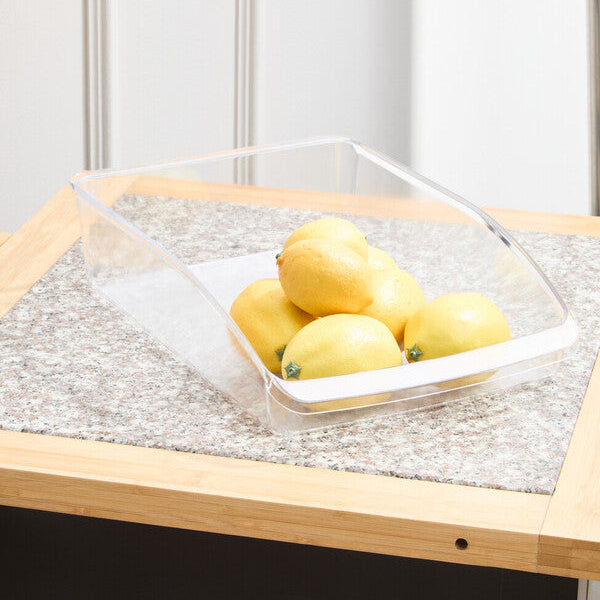 Clear container with lemons on a wooden table