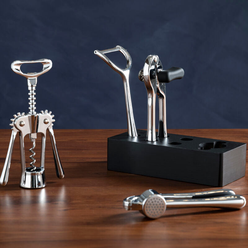 Set of corkscrew and bottle openers on a wooden surface with a dark background