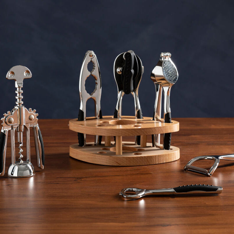 Set of corkscrews on a wooden stand with a dark background