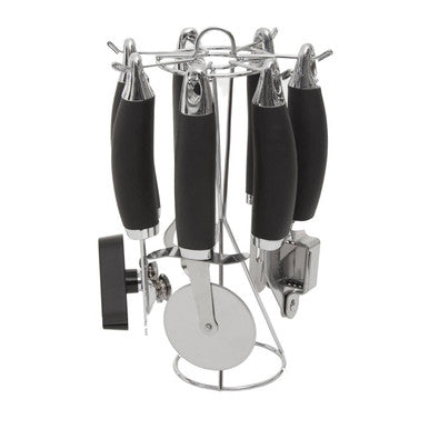 Set of kitchen utensils with black handles on a chrome stand against a white background