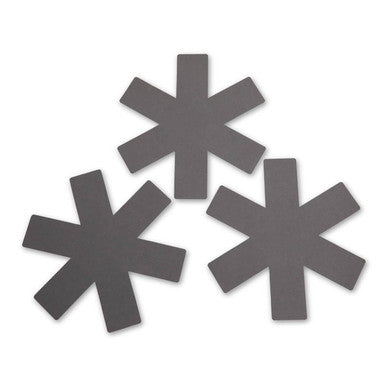 Three star-shaped black magnetic strips on a white background
