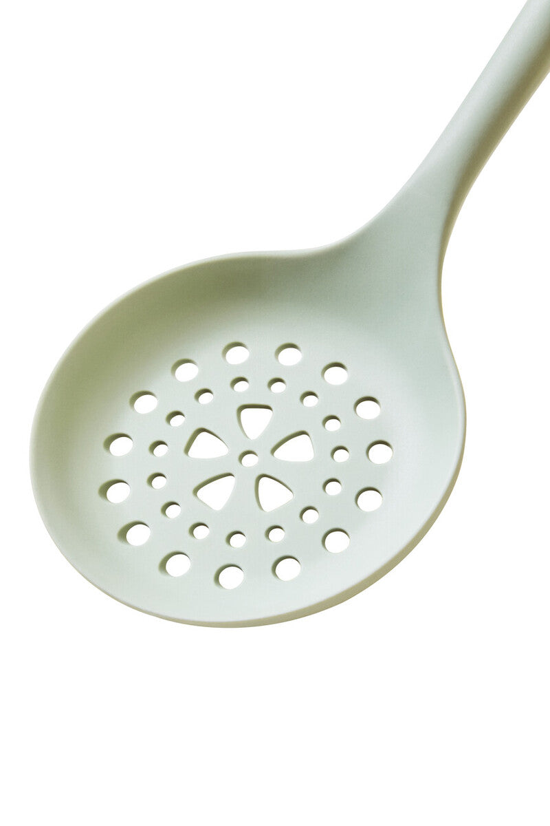 White slotted spoon on a white background