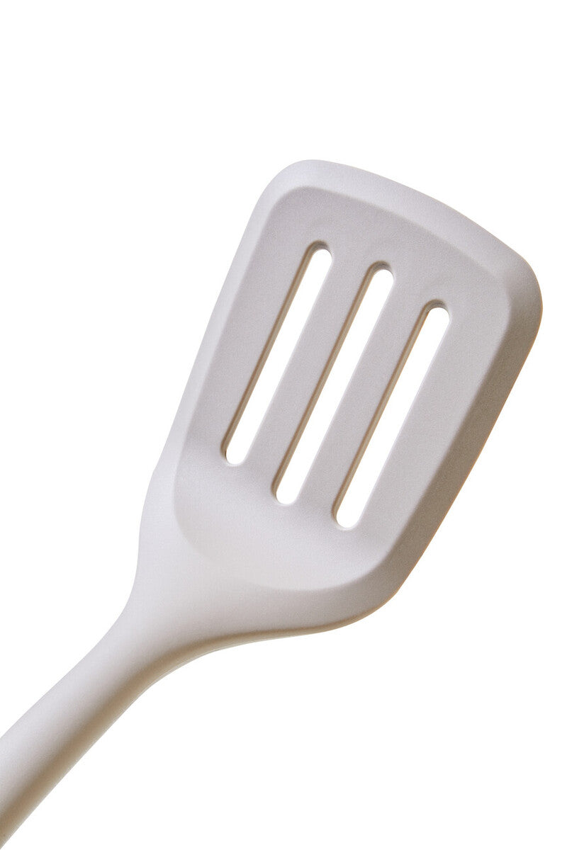 White slotted spatula on a white background