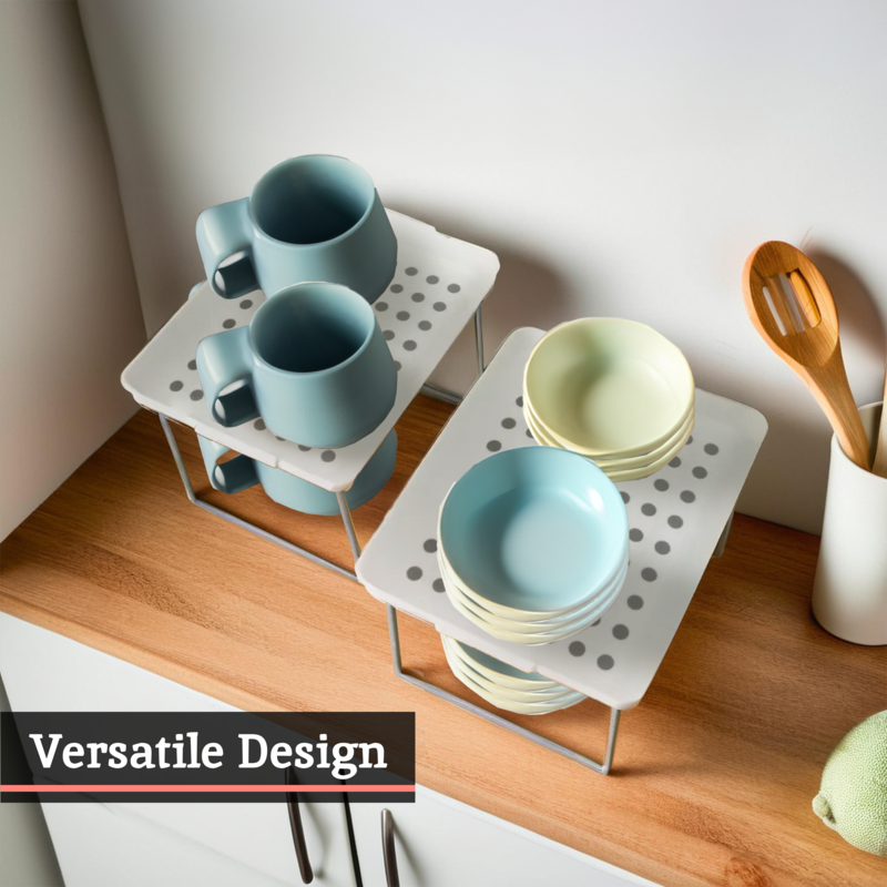 Set of blue and green ceramic dishes on a white perforated rack with wooden utensils on a wooden surface.