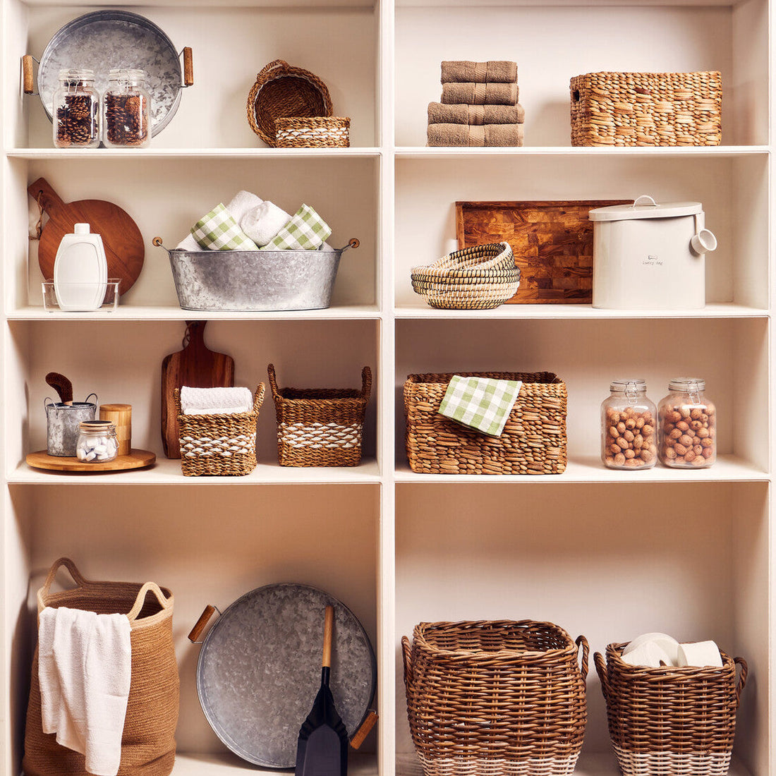Shelves with various baskets, jars, and kitchen items on a neutral background
