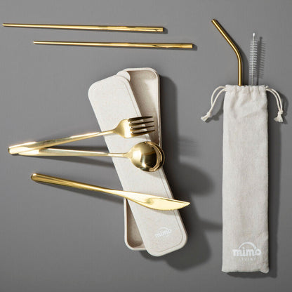 Set of gold cutlery and straws with a carrying case on a gray background