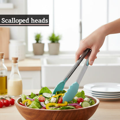 Person using salad tongs to serve a salad from a wooden bowl in a kitchen setting.