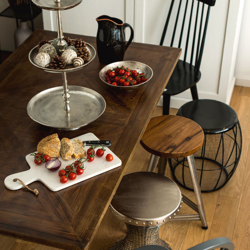 Dining table with food and chairs in a kitchen setting