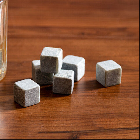 Glass of whiskey with whiskey stones on a wooden surface