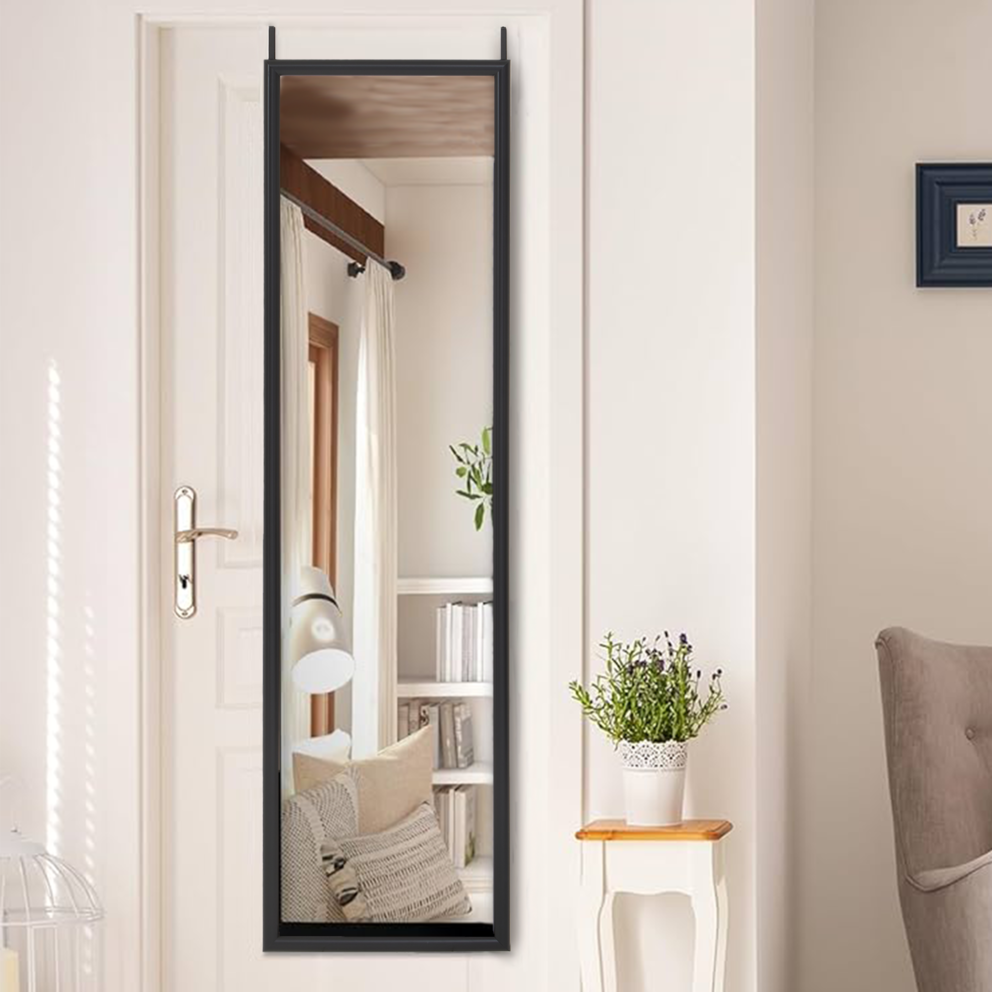 Full-length mirror leaning against a wall in a room with a chair and small table.