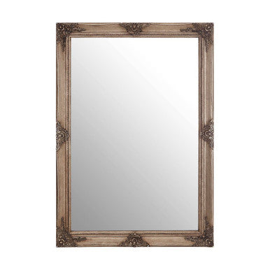 Decorative wall mirror with ornate frame on a white background