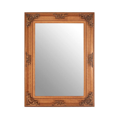 Decorative wooden mirror with intricate carvings on a white background
