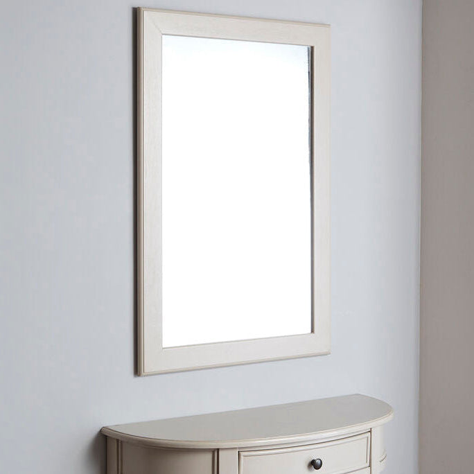 Small console table with a mirror above it against a light gray wall.