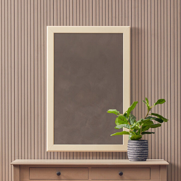 Console table with a mirror, plant, and basket against a striped wall.