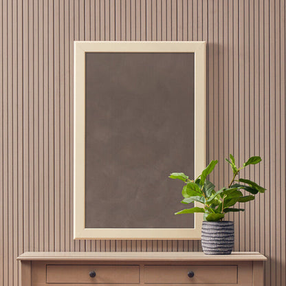 Console table with a mirror, plant, and basket against a striped wall.