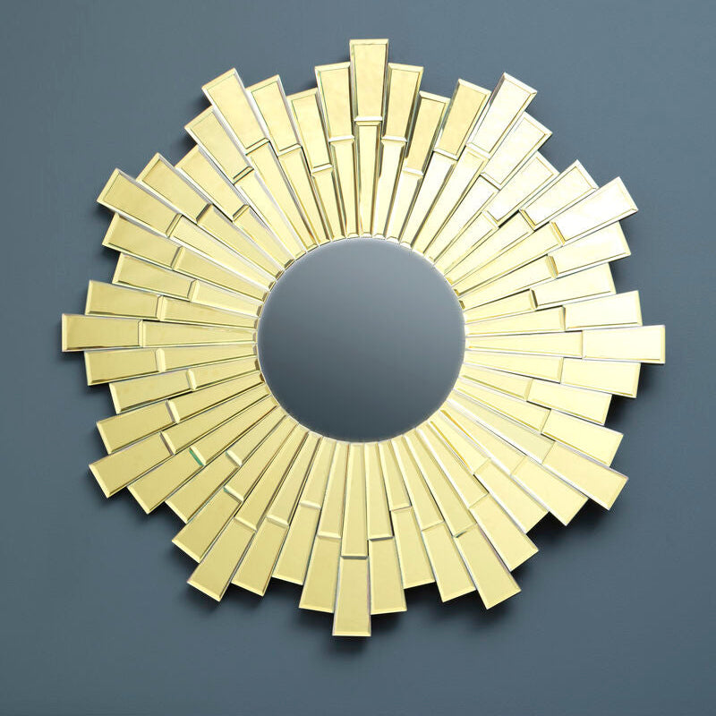 Gold decorative mirror on a dark blue wall