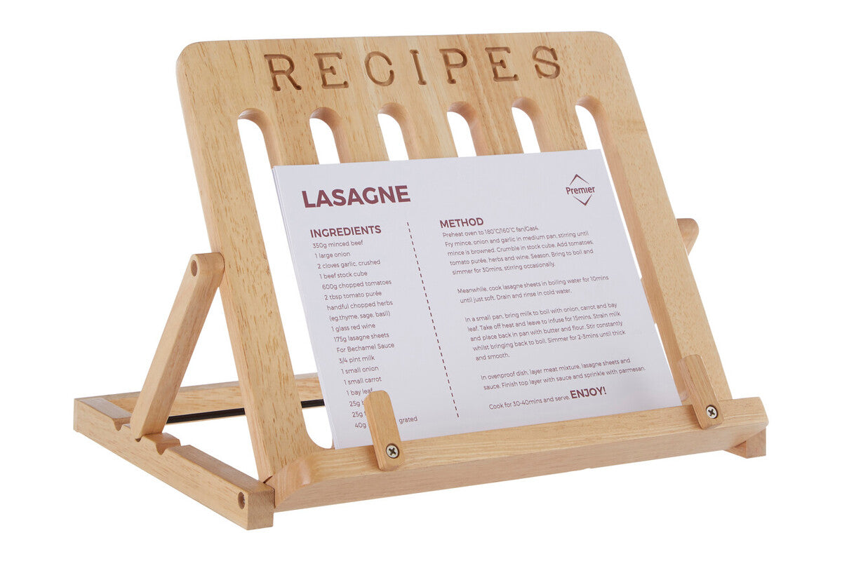 Wooden recipe stand holding a sheet of paper with a lasagne recipe.