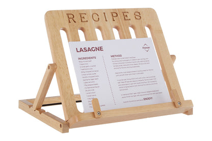 Wooden recipe stand holding a sheet of paper with a lasagne recipe.