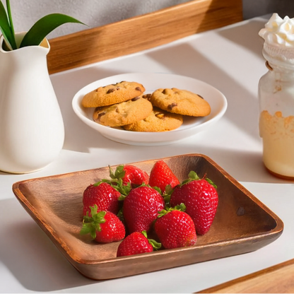 Table setting with strawberries, cookies, and a milkshake on a tray, featuring a hand-carved design text.