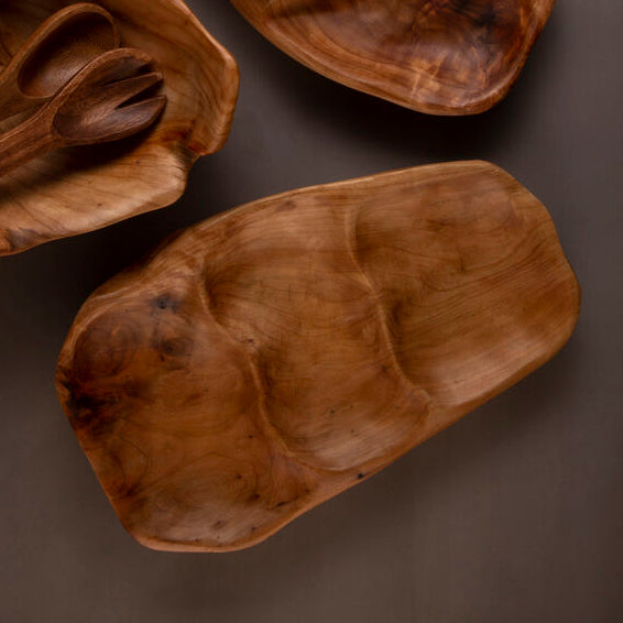 Three wooden bowls with oranges on a dark background