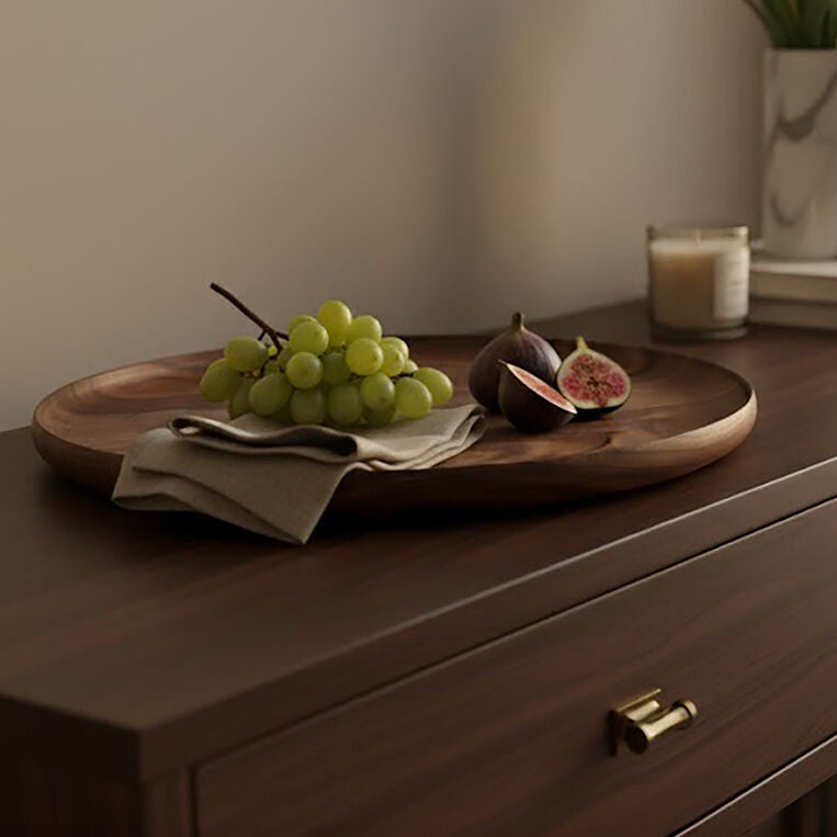 Wooden dresser with a tray of grapes and figs, a candle, and a vase of white tulips.