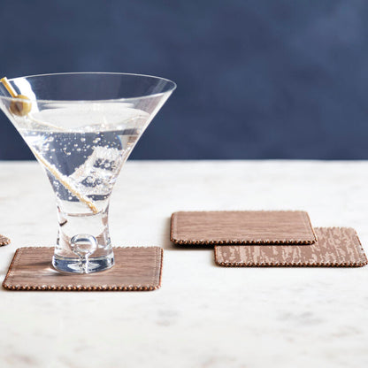 Martini glass with a cocktail on a marble surface with coasters