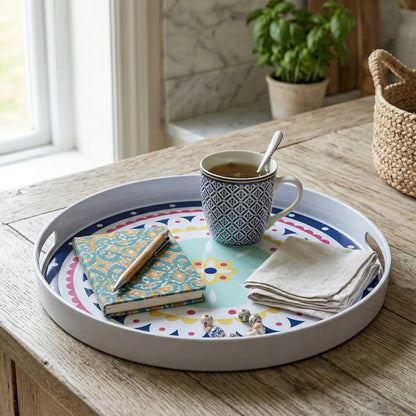 Decorative tray with a mug, notebook, and napkins on a wooden table.