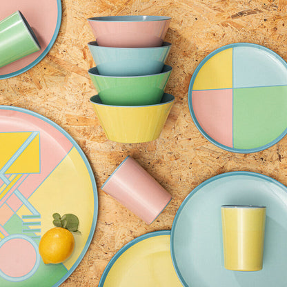 Colorful ceramic plates and bowls on a wooden surface