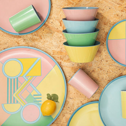 Colorful ceramic plates and bowls on a wooden surface
