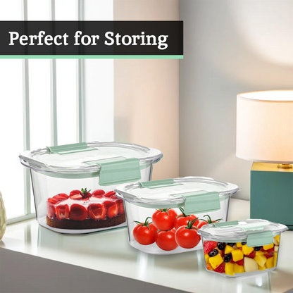 Glass food storage containers with lids on a kitchen counter, containing fruits and vegetables.