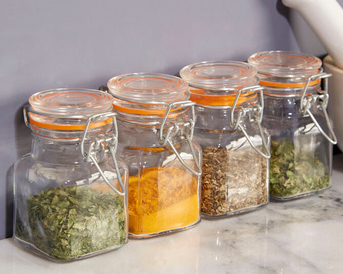 Set of glass jars with spices on a kitchen counter