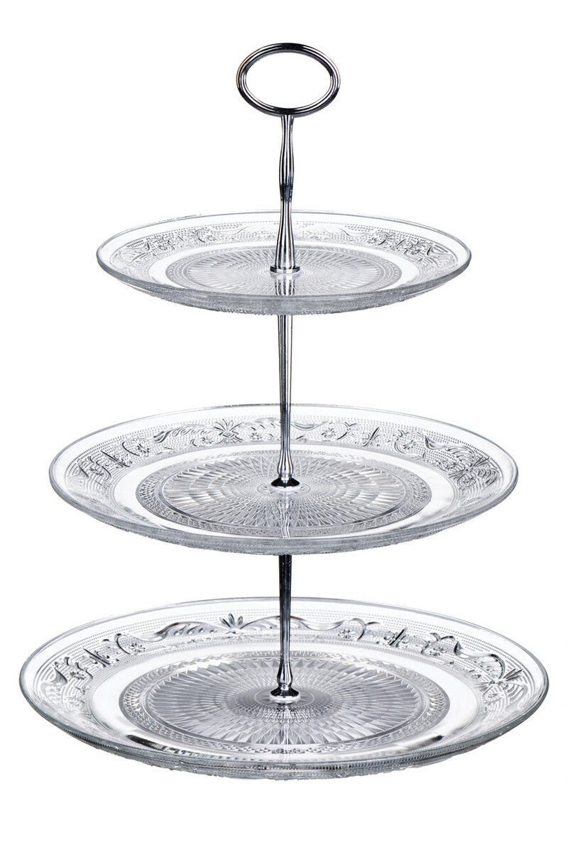 Three-tiered glass cake stand with decorative patterns on a white background