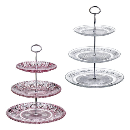 Two three-tiered glass cake stands with decorative patterns on a white background